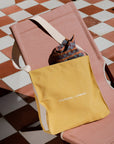 Yellow bag with 'PEDERSEN + LENNARD' text on a checkered floor