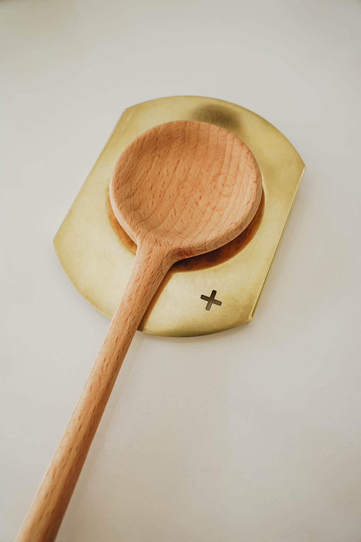 brass spoon rest with wooden spoon