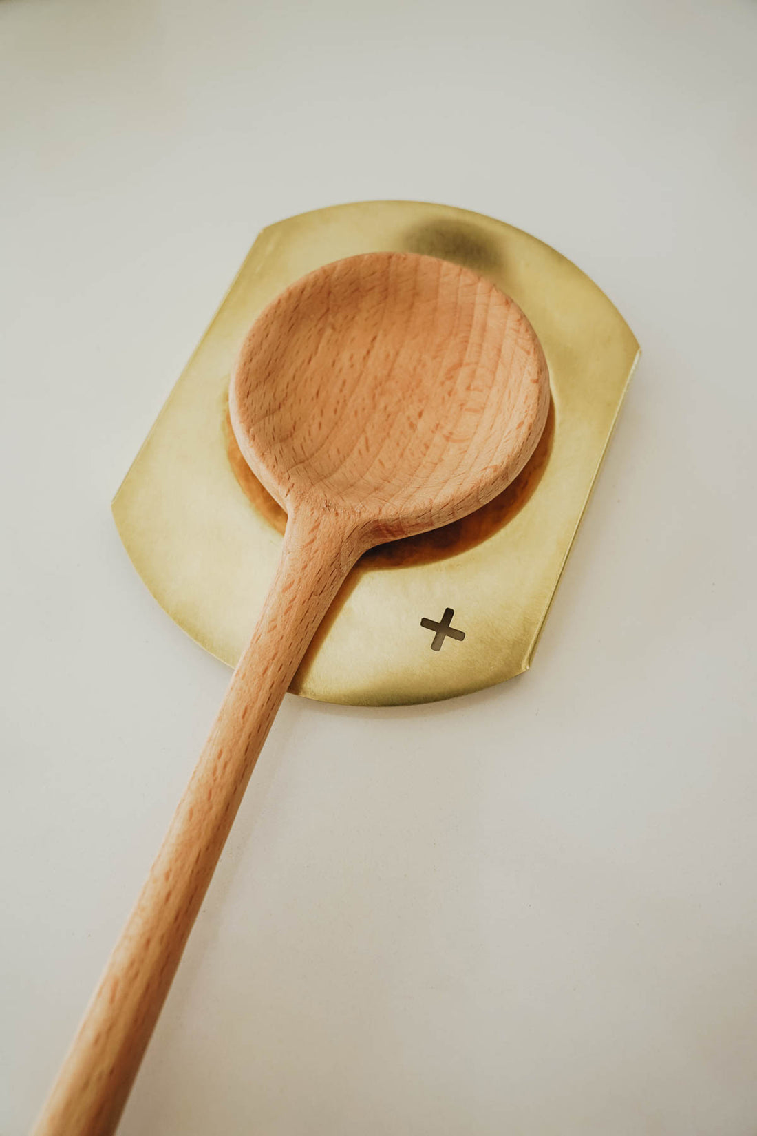 brass spoon rest with wooden spoon