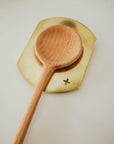 brass spoon rest with wooden spoon