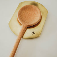 brass spoon rest with wooden spoon